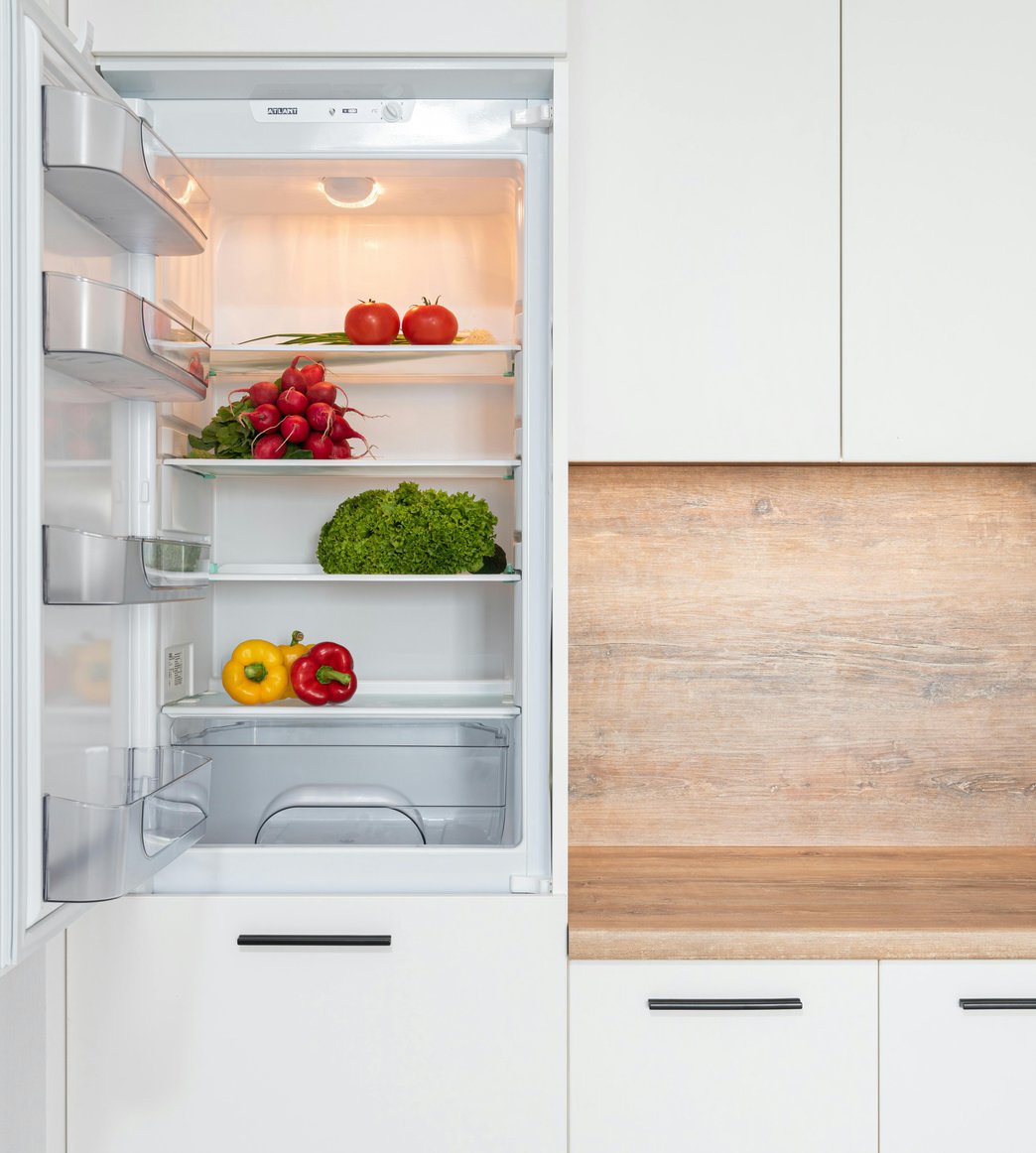 Technician diagnosing refrigerator cooling issue