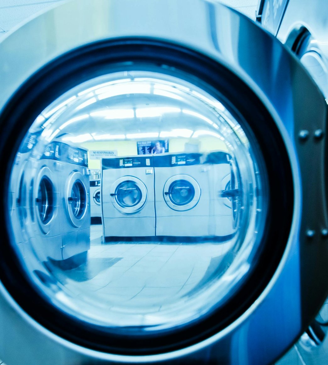 Technician servicing a kitchen microwave and upper appliance zone